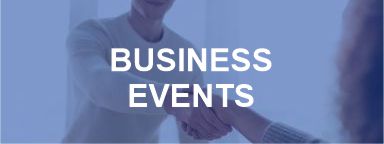 A business event with two people shaking hands.
