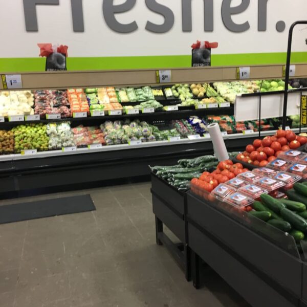 a produce section of a grocery store filled with fresh fruits and vegetables.