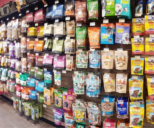 a store filled with lots of bags of pet treats and food.
