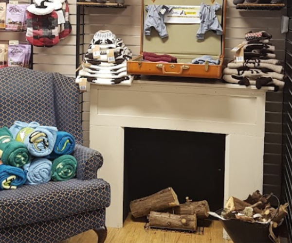 a pet blanket display of a blue chair sitting in a room next to a fire place