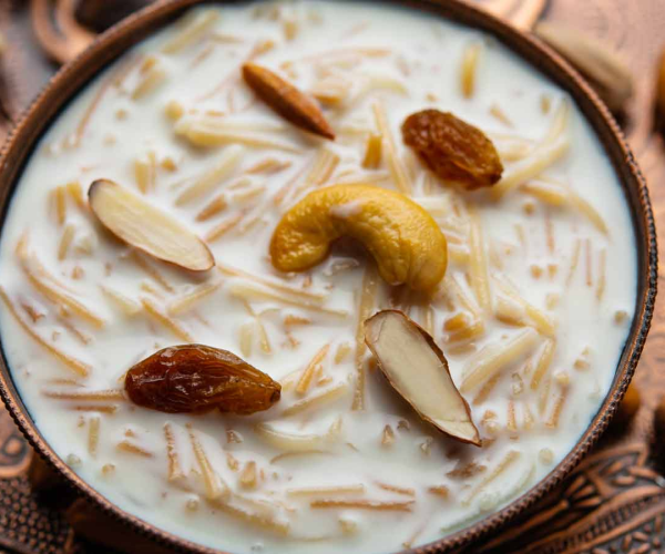 a bowl of yogurt with nuts and raisins.