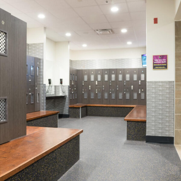 a locker room with benches and lockers in it.