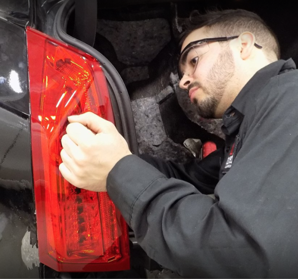 a man working on a car tail light.