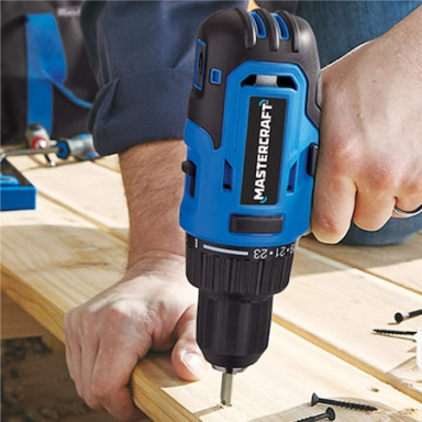 a man using a drill to attach a piece of wood.