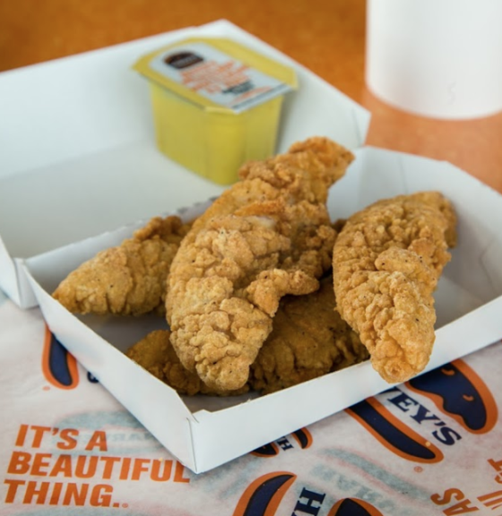 four chicken fingers with dipping sauce