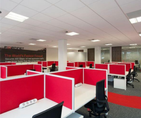an office cubicle with red and white cubicles.
