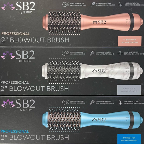 a close up of three different blowout brushes on a table.
