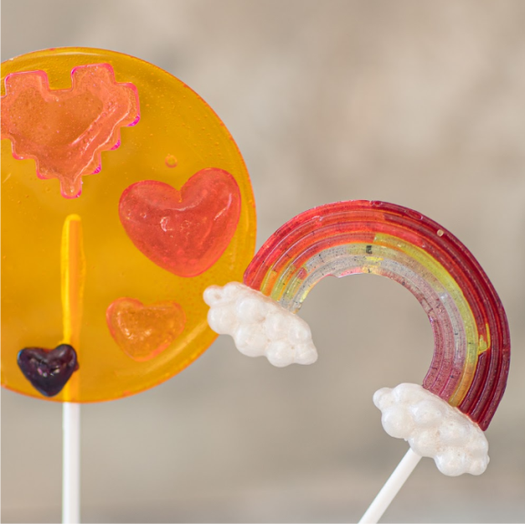 a couple of handmade lollipops sitting on top of a stick.
