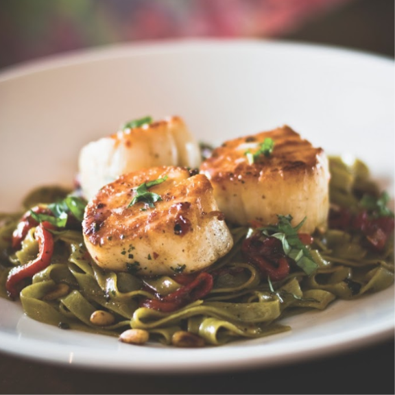 Scallops on a bed of spinach linguine