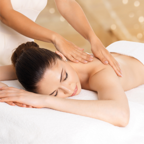 a woman getting a back massage at a spa.