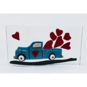 a picture of a blue truck with hearts on it.