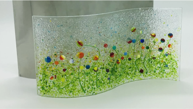 a glass sculpture of a field of flowers.
