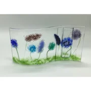 a glass vase with flowers painted on it.