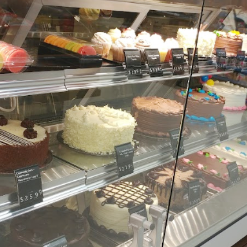 a display case filled with lots of cakes.