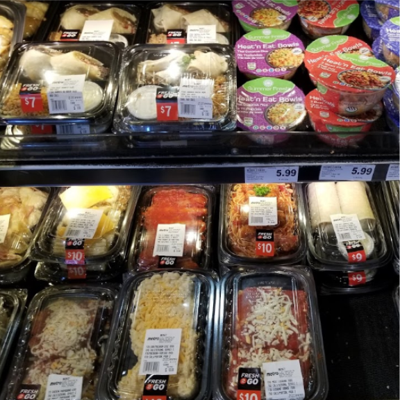 a display case filled with lots of different types of ready-to-eat food.