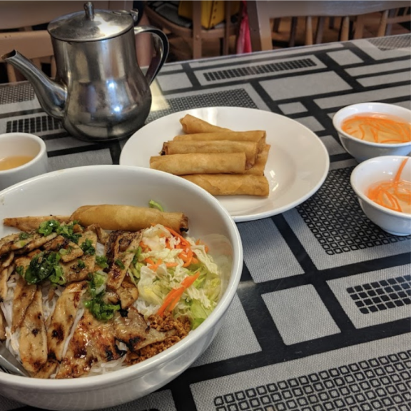 Chicken noodle bowl with spring rolls and tea