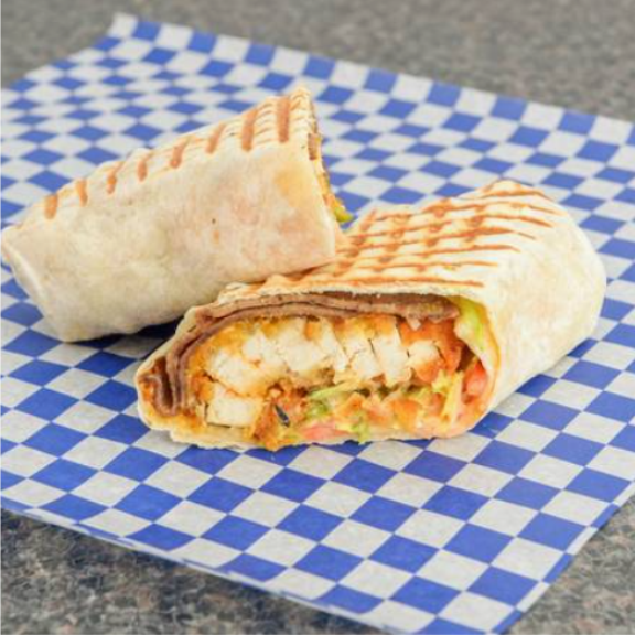 a chicken wrap sitting on top of a blue and white checkered paper.
