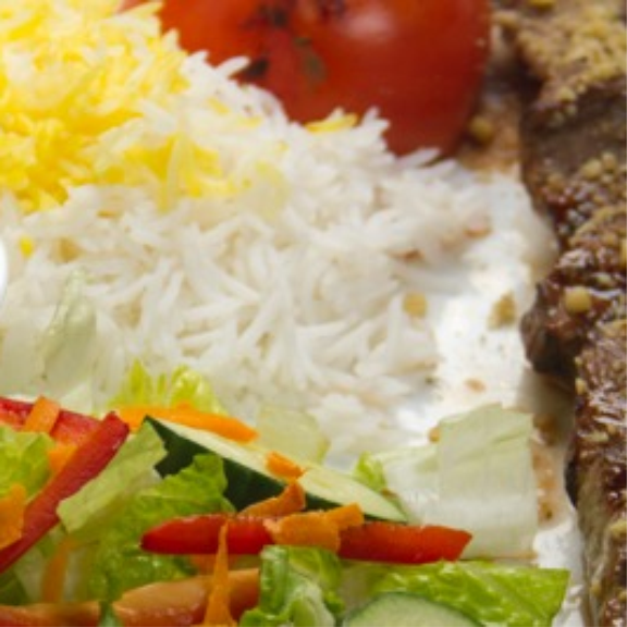 a close up of a plate of food with meat and rice.