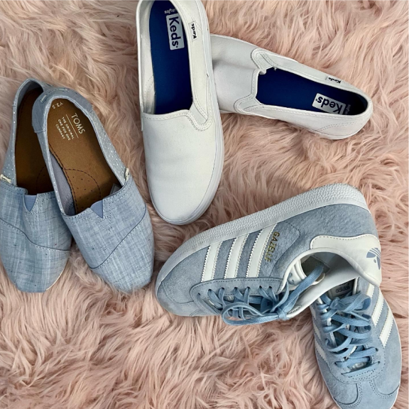 three pairs of blue and white adidas shoes.