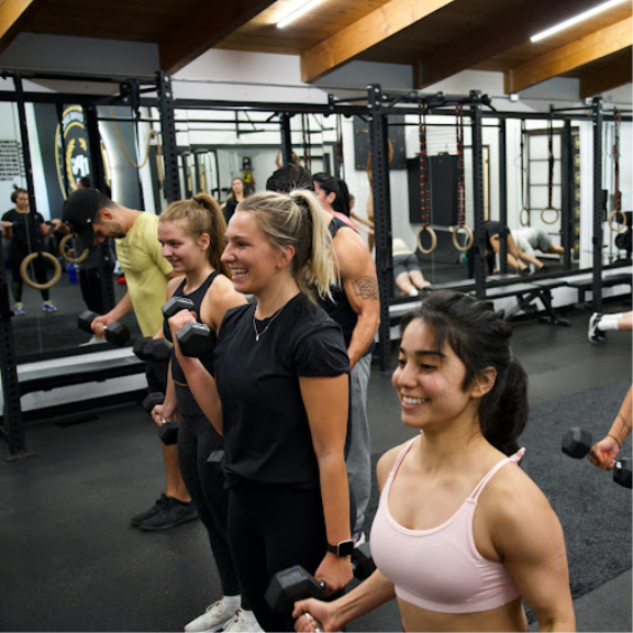 a group of people working out in a gym.