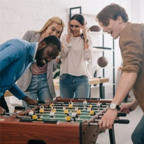a group of people playing a game of foozeball