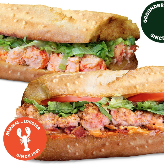 a lobster sandwich with meat, lettuce and tomato on it.