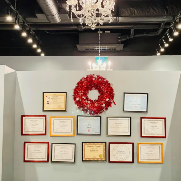 a wall with a bunch of award plaques and a wreath on it.