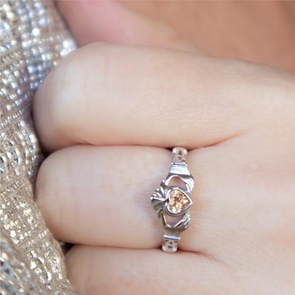 a close up of a person wearing a ring.