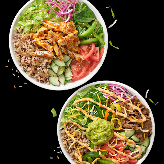 two bowls filled with different types of salads