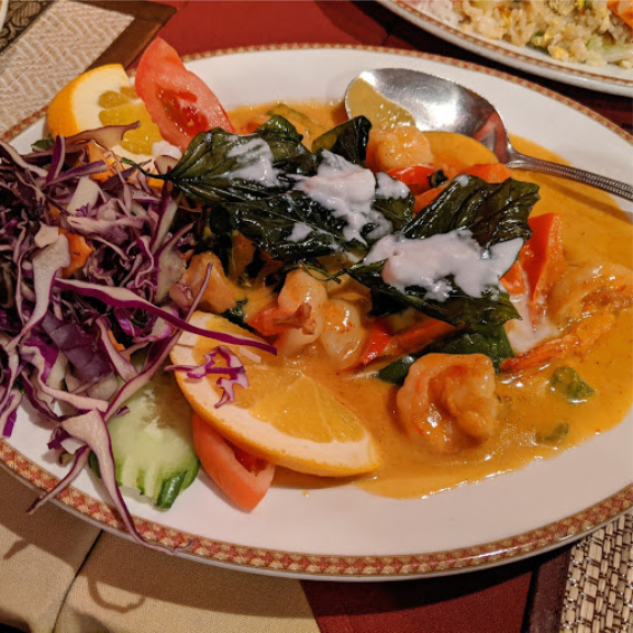 a white plate topped with shrimp and vegetables.