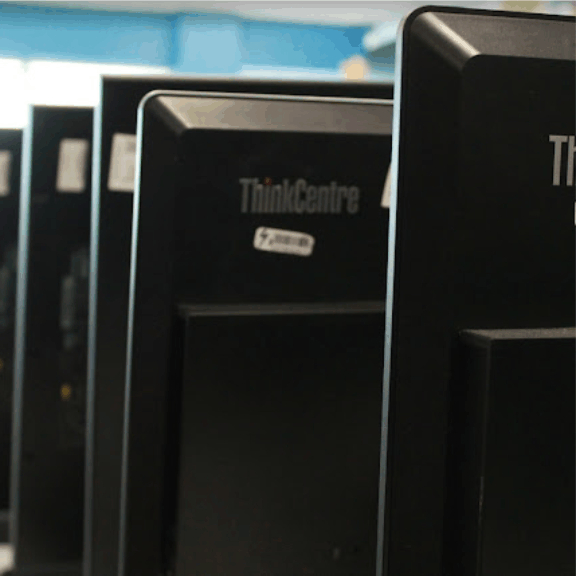 a row of black computer monitors sitting next to each other.