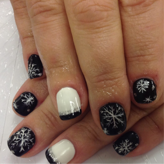 a woman's hand with black and white snowflakes on it.