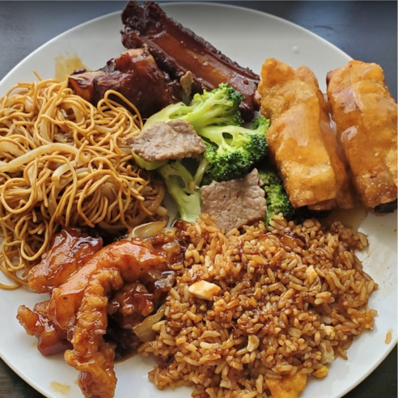 a plate of food with meat, noodles, egg rolls and broccoli.