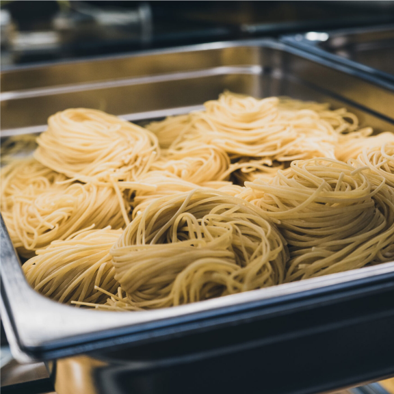 a bunch of noodles in a pan on a table.