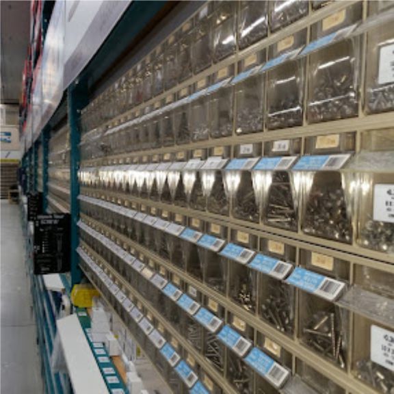 long hall of individual compartments showing vast selection of nuts, bolts, and screws