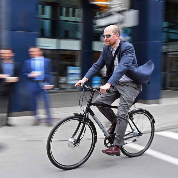 a man riding a bike down a street.