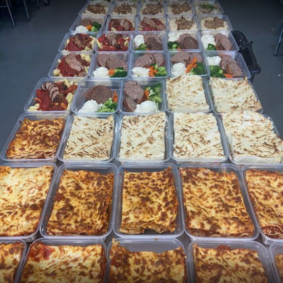 large table of individual meals like lasagna, shepherd's pie, and pasta
