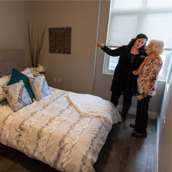 Showing elderly woman tour of apartment
