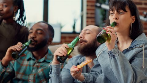 a group of people drinking beer and laughing
