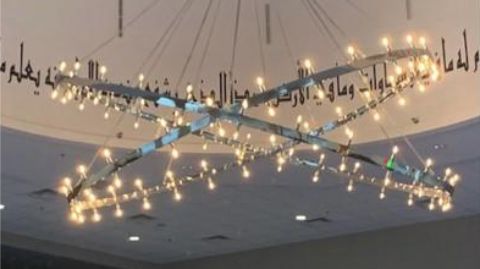 a chandelier with lights hanging from it's ceiling.