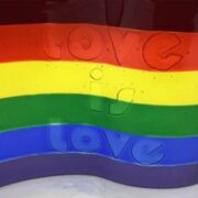 a gay pride flag with the word love written on it.