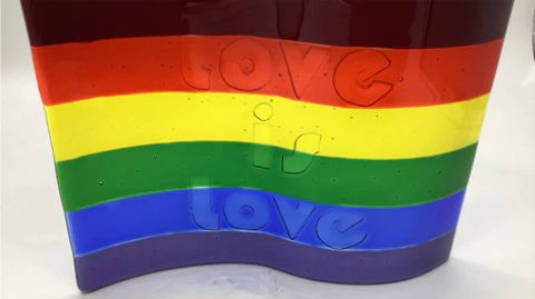 a gay pride flag with the word love written on it.