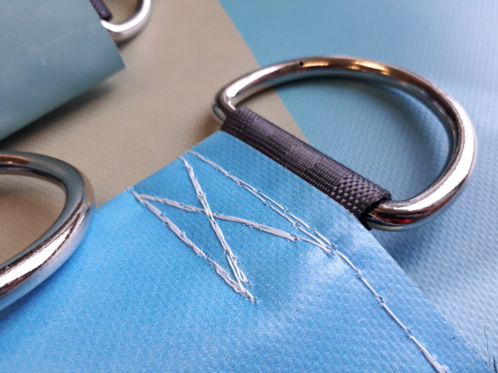 a pair of metal rings on a blue cloth.