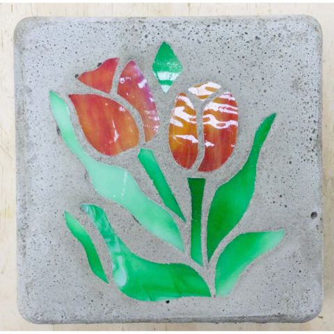 a stained glass tile with tulips on it.
