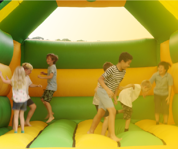 A group of children playing in an inflatable bounce house.