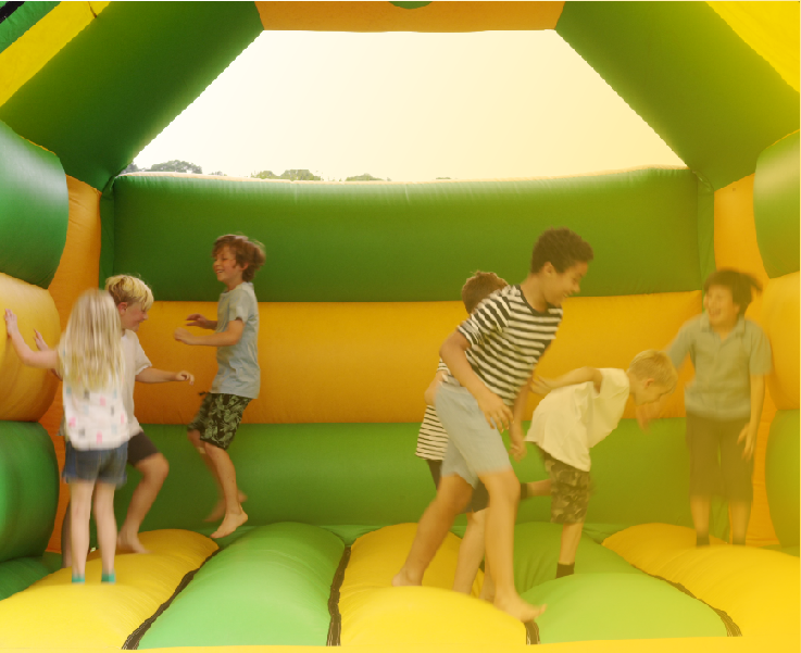 A group of children playing in an inflatable bounce house.