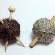 A pair of knitting needles and a ball of yarn.