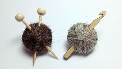 A pair of knitting needles and a ball of yarn.