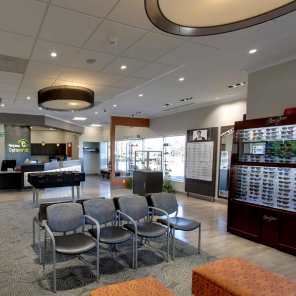 An image of an eye care office with chairs and tables.
