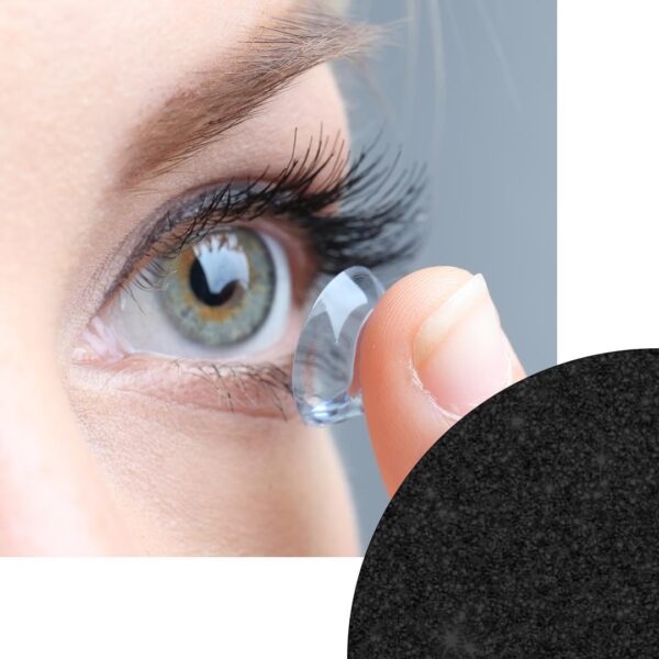 A woman is putting contact lenses on her eye.